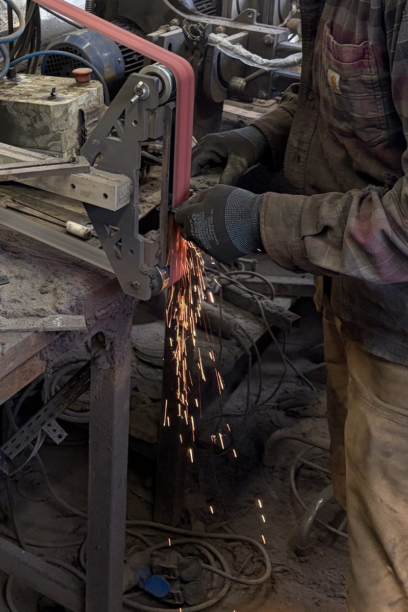 Sparks flying from the belt grinder
