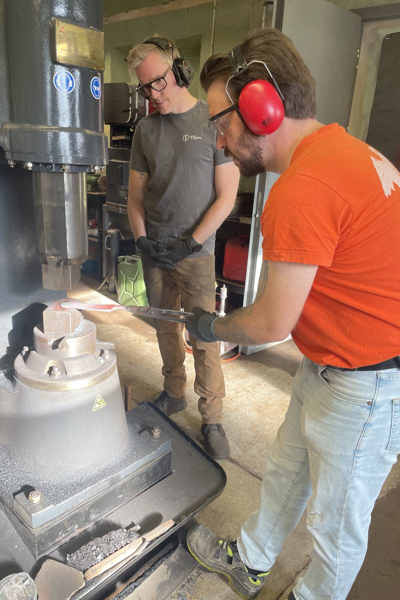 A participant forging under the power hammer