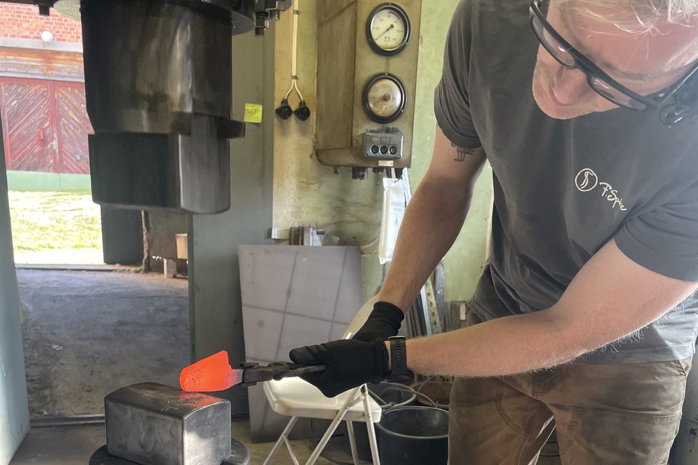 Fredrik forging hot steel under the power hammer